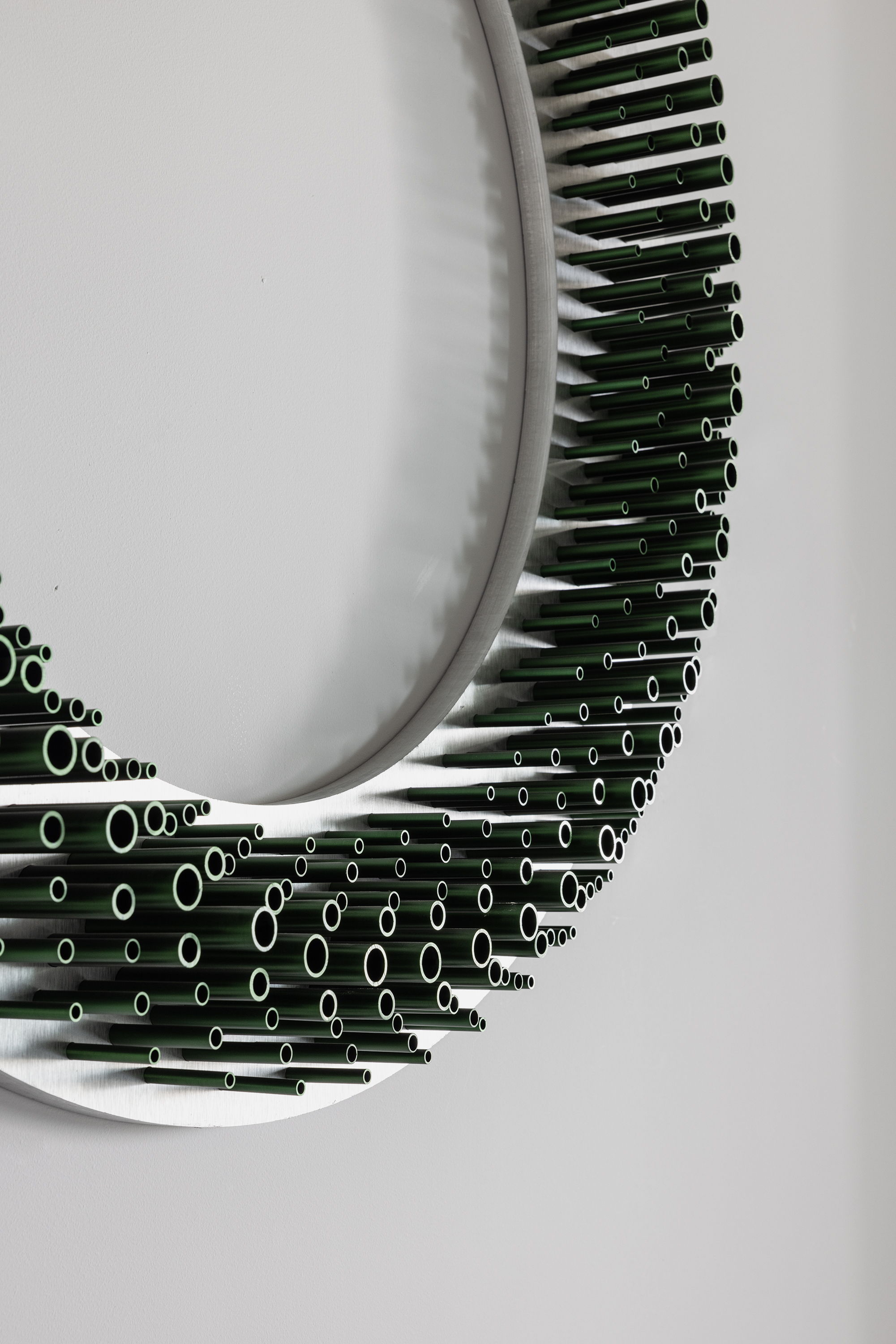 Close detail of a Cato ring built from hundreds of green tube segments.