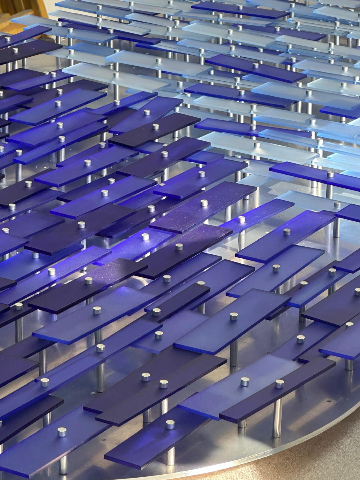 Data Cloud from below — hand-dyed plexiglass pieces catching the light overhead.